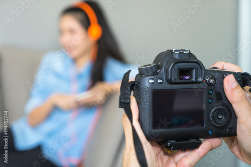 Close up man hands holding digital camera taking photo of model woman. © NopponPAT