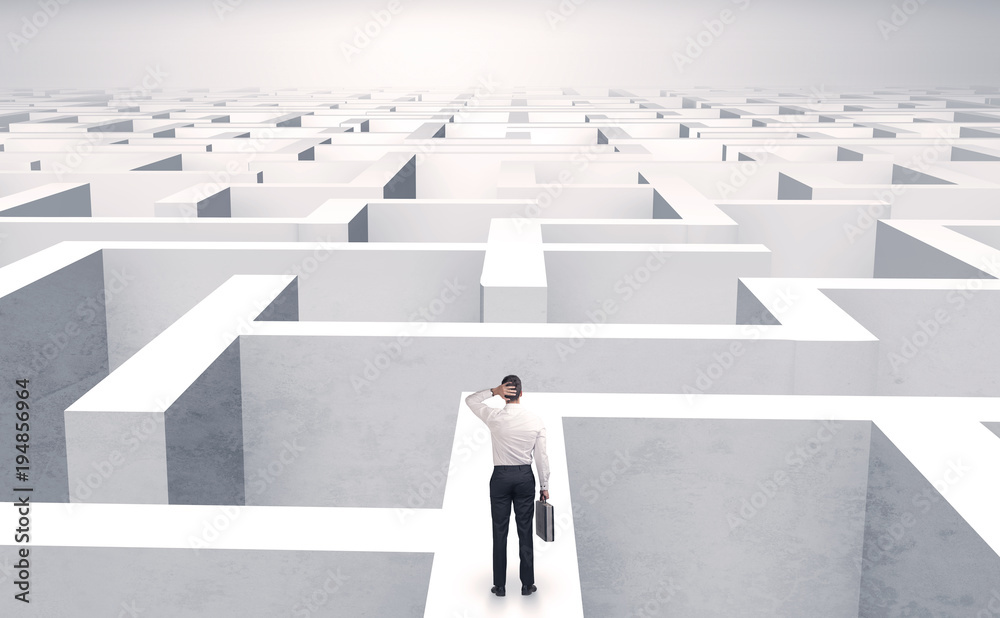 Small businessman in a middle of a maze Small businessman in a middle of a maze
