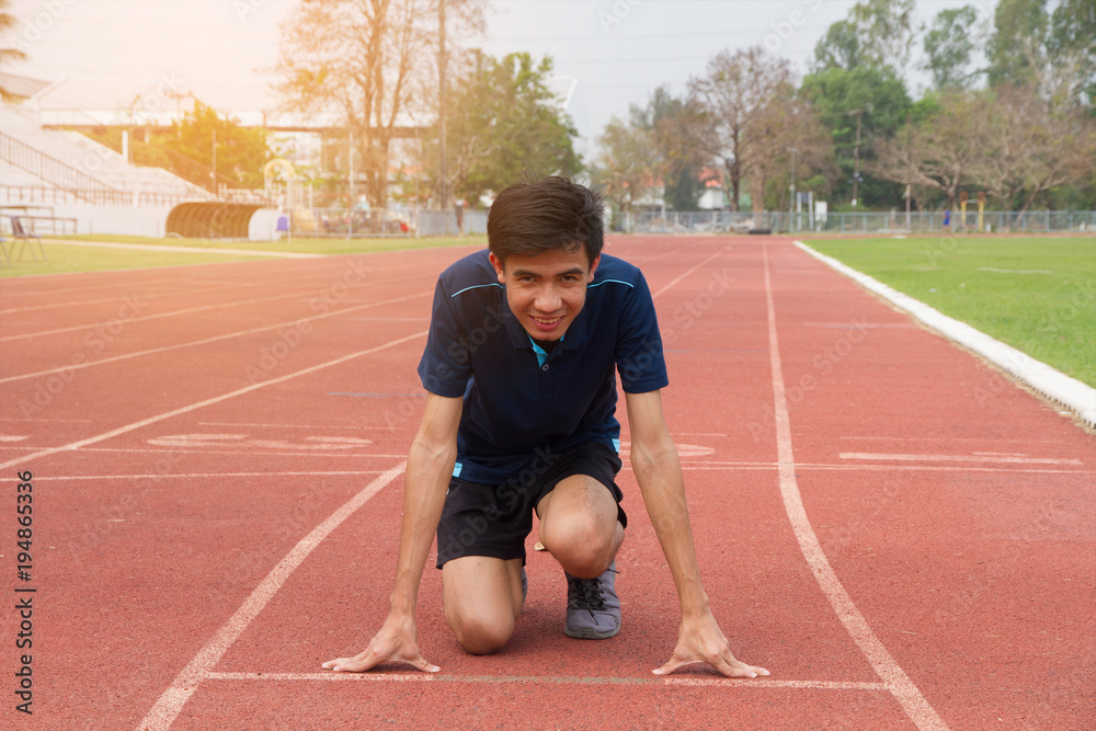 Asian man ready start run on track stadium