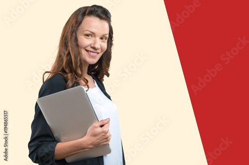Portrait of young beautiful brunnete woman holding laptop photo