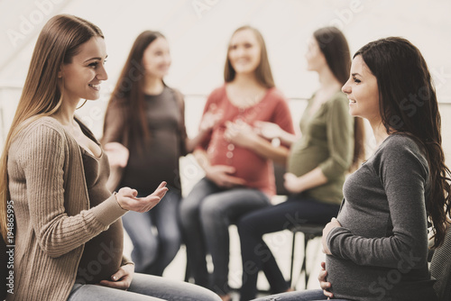 Happy pregnant women are talking together at antenatal class at the hospital