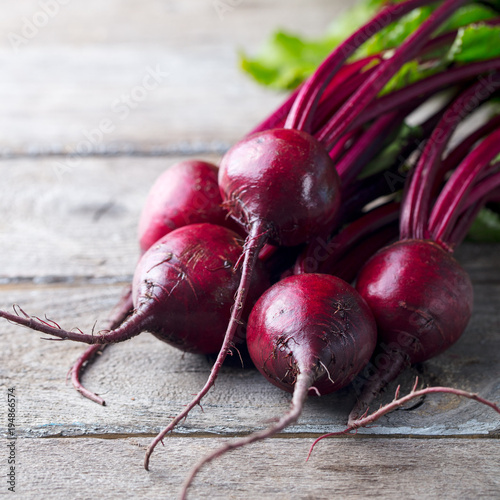 Fresh organic beet, beetroot on grey rustic wooden background. photo