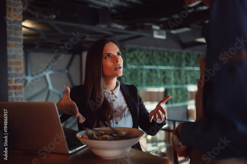 Portrait of woman complaining about food quality and taste in restaurant.