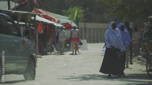 Crowds walk down the streets shopping at village beach town in Nungwi, Zanzibar.