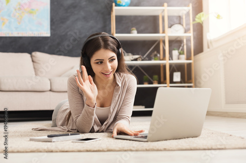 фотографія Girl at home communicating on skype in internet