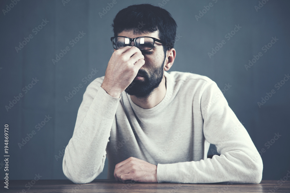 sad man in formal clothes touching his nose sad man in formal clothes touching his nose
