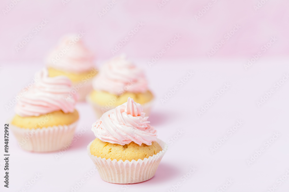 Cupcake decorated with pink buttercream on pastel pink background. Sweet beautiful cake. Horizontal banner, greeting card for birthday, wedding, women's day. Close up photography. Selective focus Cupcake decorated with pink buttercream on pastel pink background. Sweet beautiful cake. Horizontal banner, greeting card for birthday, wedding, women's day. Close up photography. Selective focus