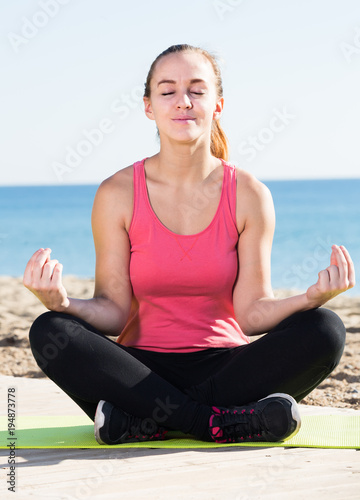 young girl exercising on exercise mat outdoor