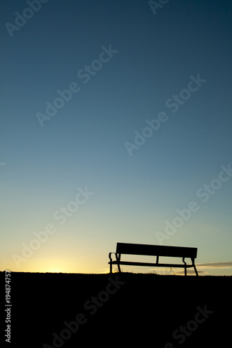 Silhouette chair on Sunset background.
