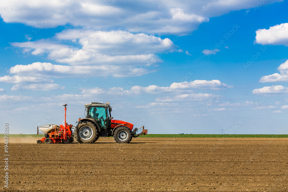 Farmer seeding, sowing crops at field. Sowing is the process of planting seeds in the ground as part of the early spring time agricultural activities. Farmer seeding, sowing crops at field. Sowing is the process of planting seeds in the ground as part of the early spring time agricultural activities.