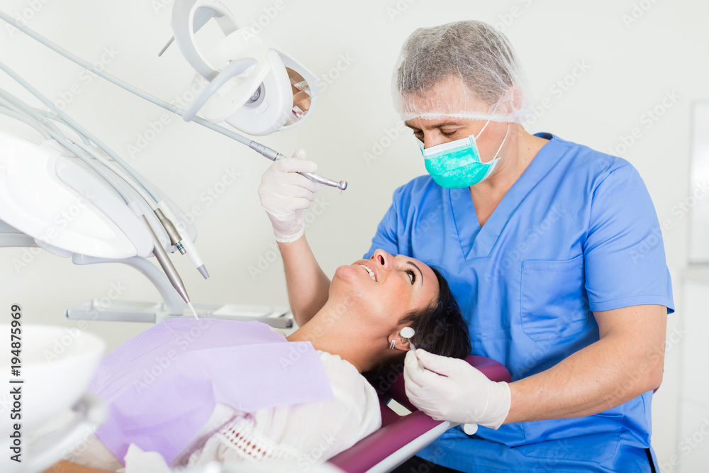 Fototapeta premium dentist professional filling teeth