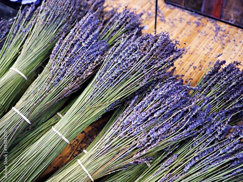 Bunch, bouquet of fresh lavender flowers, cut put on a wooden desk.  Good smell plants, stall 