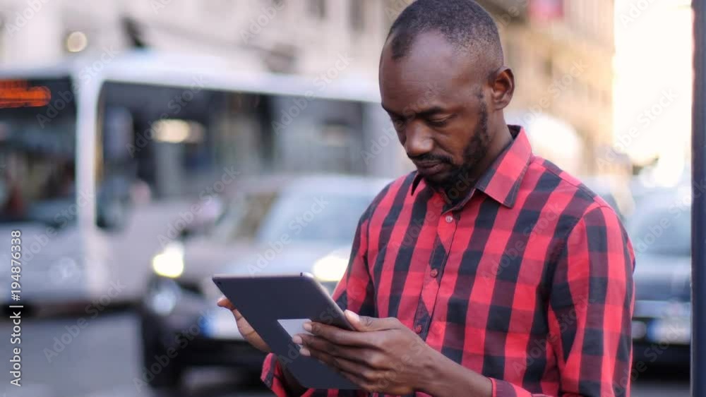Portrait of black man using digital tablet in the street Portrait of black man using digital tablet in the street
