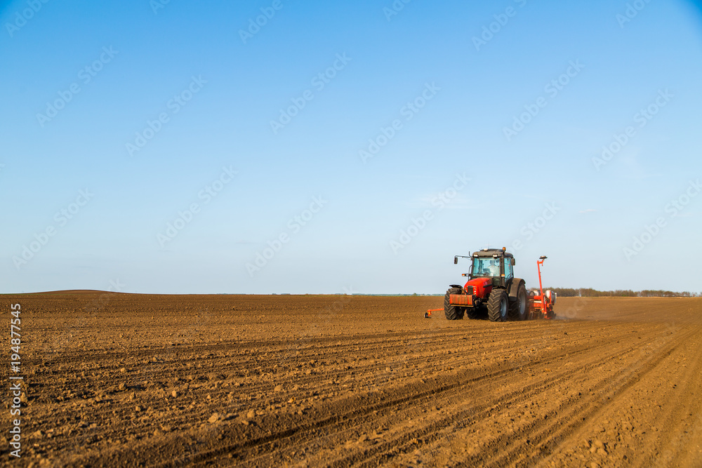 Farmer seeding, sowing crops at field. Sowing is the process of planting seeds in the ground as part of the early spring time agricultural activities. Farmer seeding, sowing crops at field. Sowing is the process of planting seeds in the ground as part of the early spring time agricultural activities.