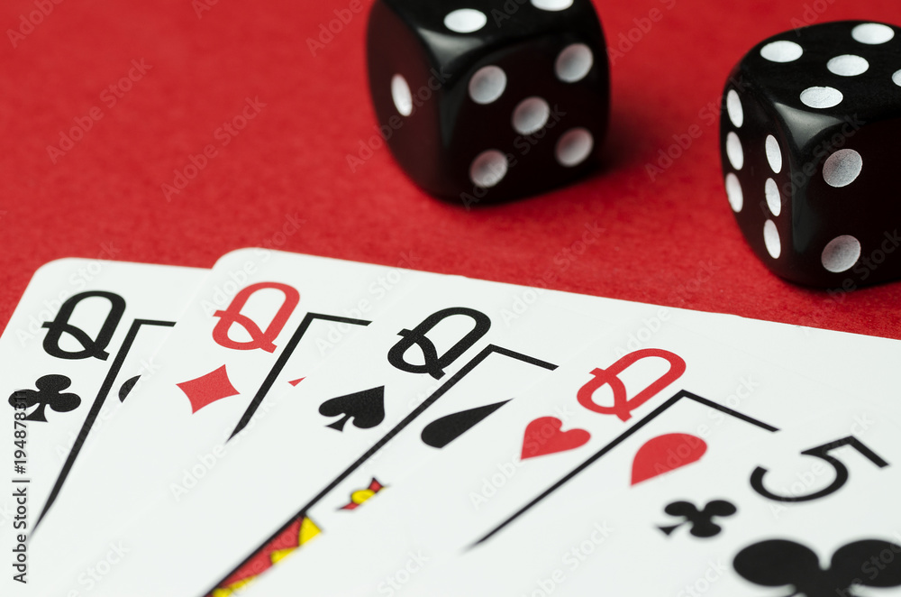 Black dice, and poker card combinations four of a kind. Red background Black dice, and poker card combinations four of a kind. Red background