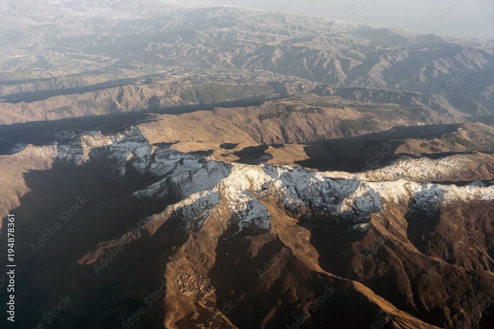Baetic Cordillera mountains with snow on mountain peak seen from an airplane