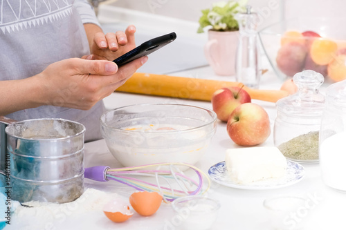 Girl photographing on kitchen. Food blogger concept