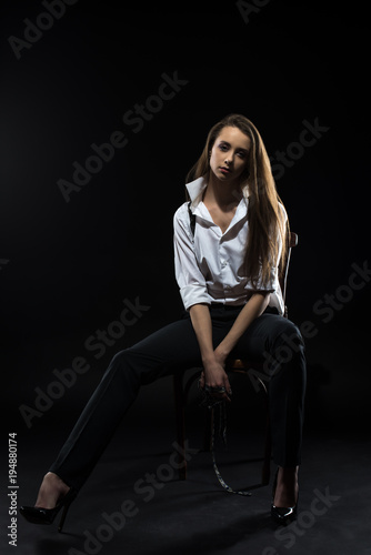 Young girl in a shirt with suspenders.
