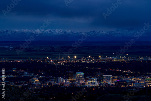 Boise city at night with the Owyhee mountains with snow and night sky