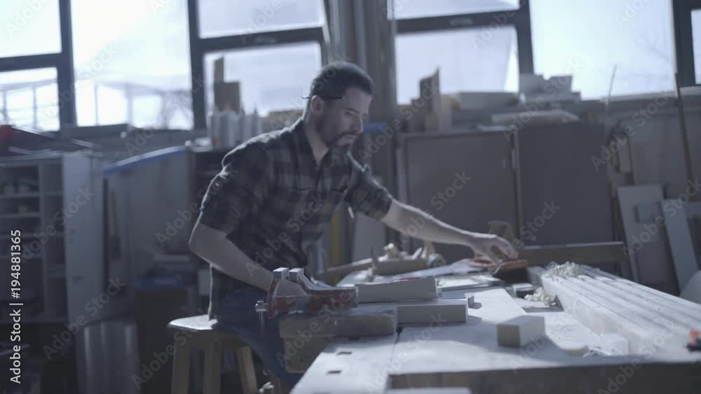Handsome man in his fourties working with wood in his workshop Handsome man in his fourties working with wood in his workshop