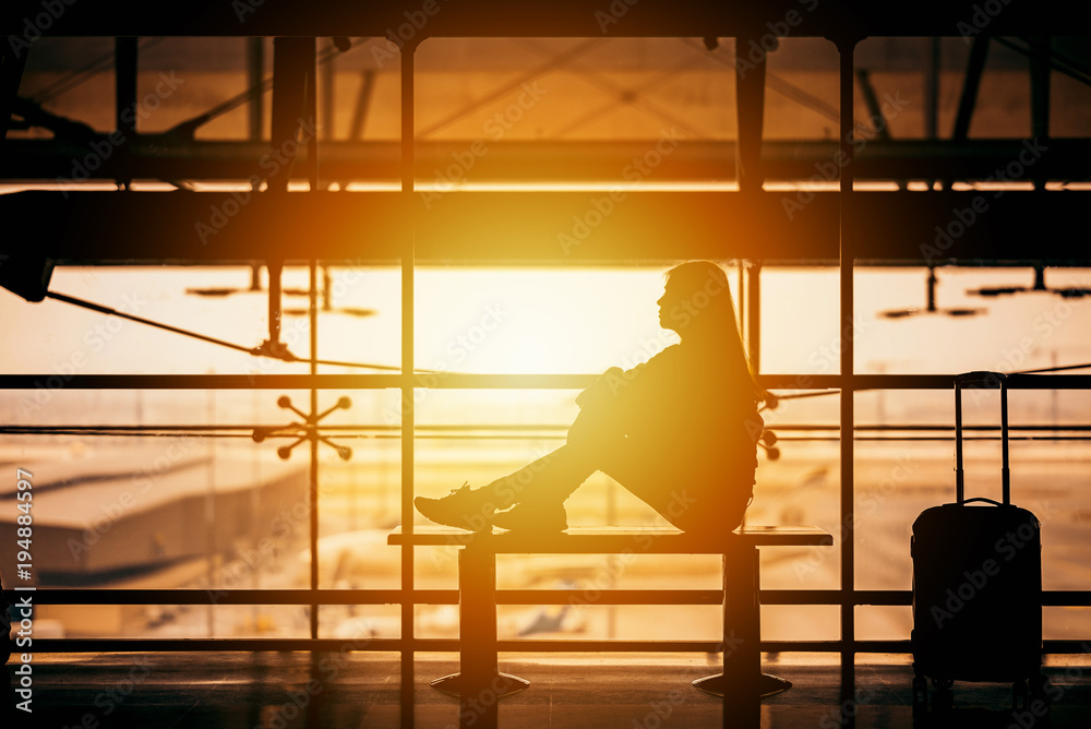 Silhouette of woman waiting in an airport