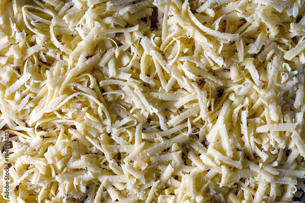 Grated cheese texture close-up top, side contour light