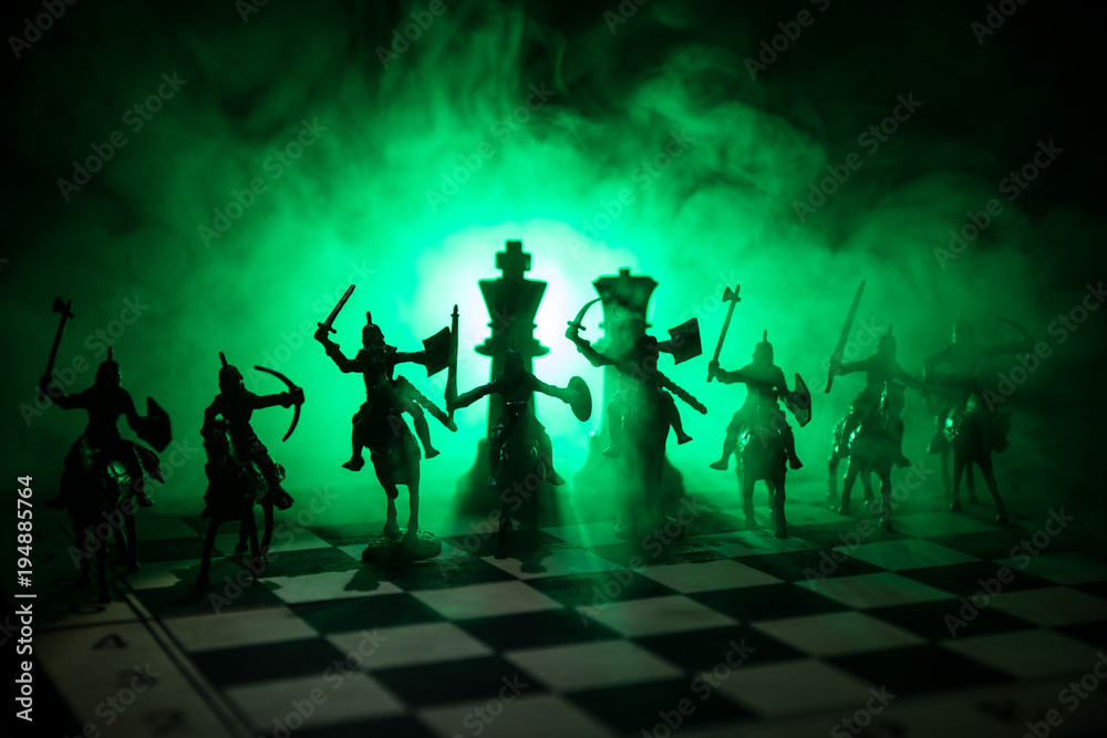Medieval battle scene with cavalry and infantry on chessboard. Chess board game concept of business ideas and competition and strategy ideas Chess figures on a dark background. Selective focus