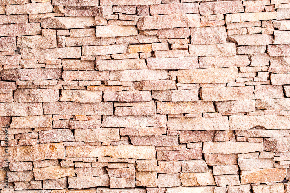 textured background made of light red stones wall textured background made of light red stones wall