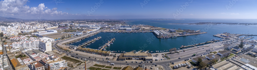 Aerial daytime view of Olhao fishing dock and seascape, waterfront to Ria Formosa natural park. Algarve.