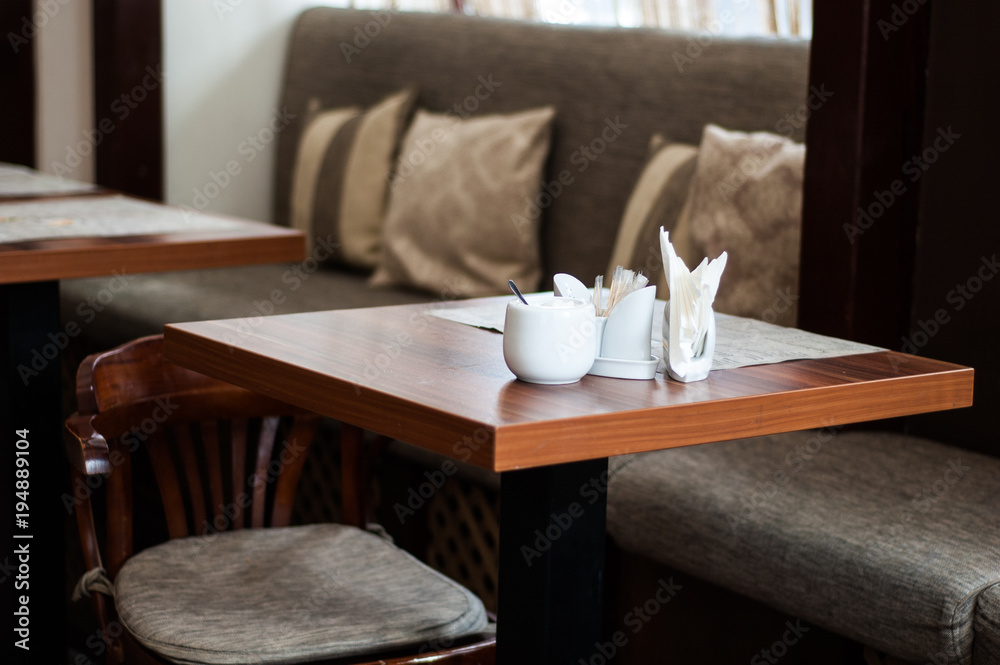 Wooden bar stools and table in the cafe. Wooden bar stools and table in the cafe.