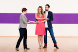 Instructor in dance school with couple of man and woman