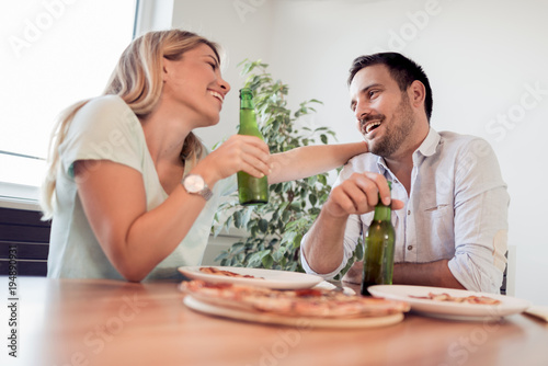Young couple enjoying eating pizza