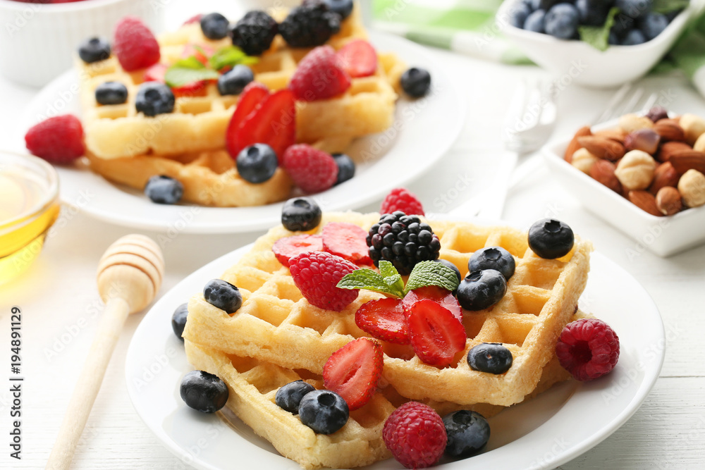 Sweet waffle with berries on white wooden table Sweet waffle with berries on white wooden table
