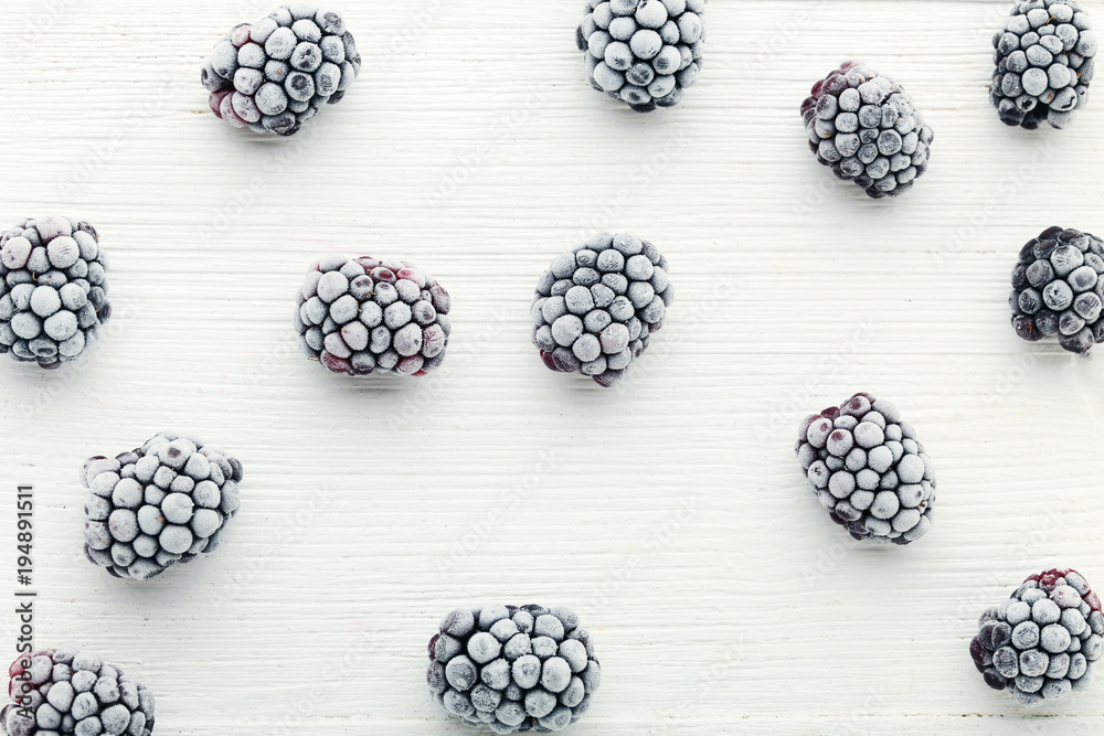 Frozen blackberries on white wooden table Frozen blackberries on white wooden table