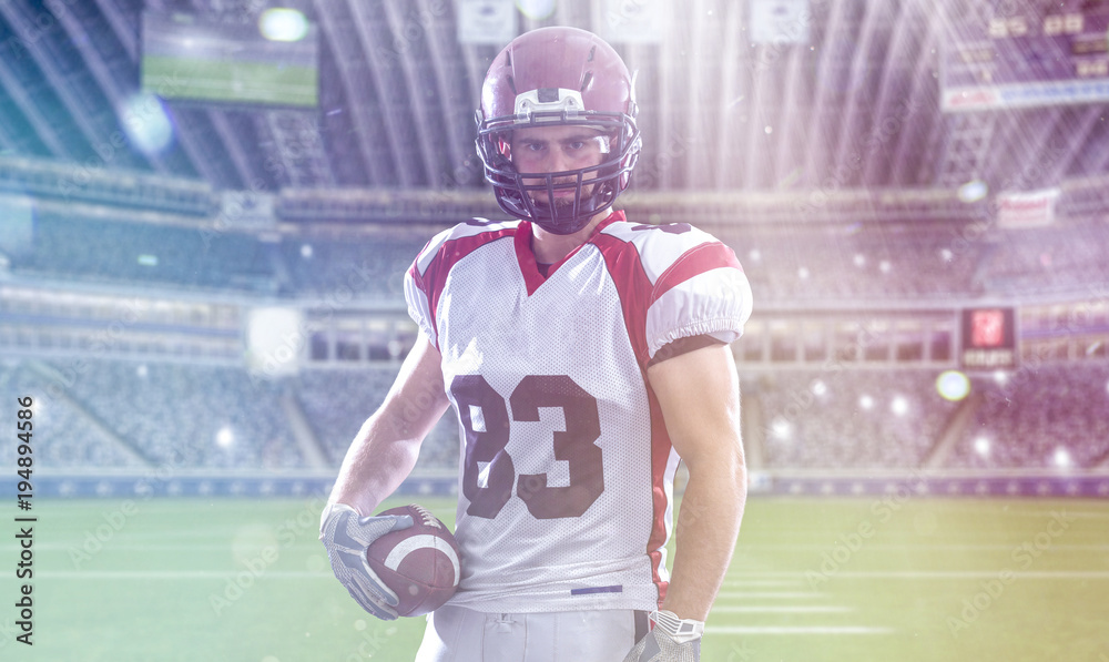 American Football Player isolated on big modern stadium field American Football Player isolated on big modern stadium field