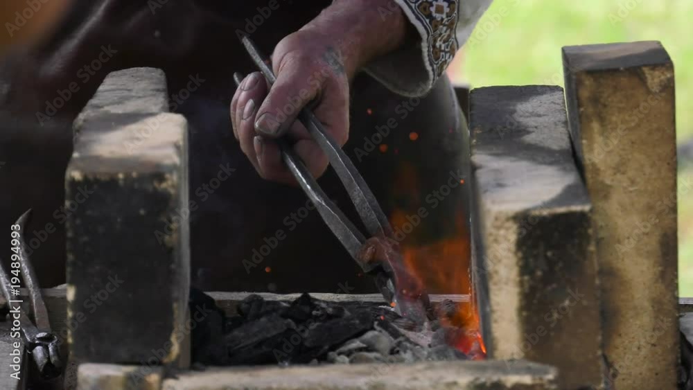 blacksmith heating up metal in coals and fire slow motion 4k blacksmith heating up metal in coals and fire slow motion 4k