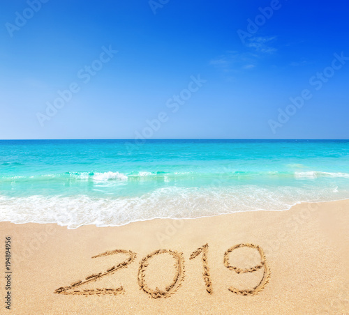 2019 written on sandy beach