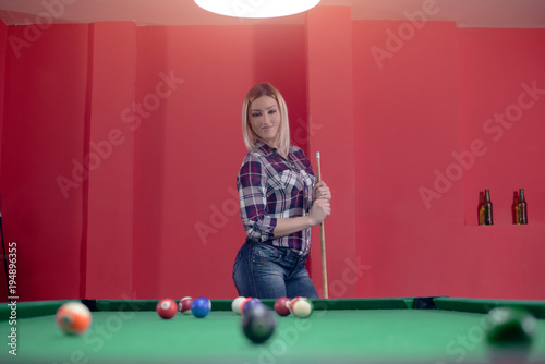 Girl is looking at the pool table © Jovan