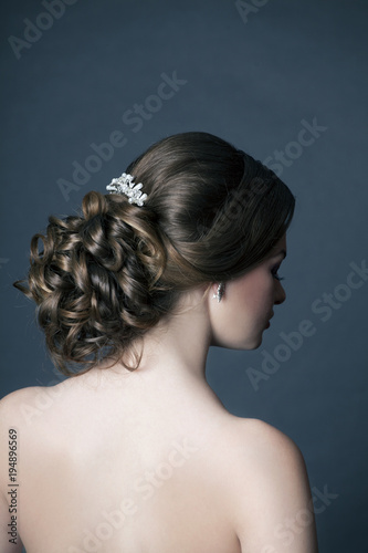 Beautiful woman's evening hairstyle from the back.