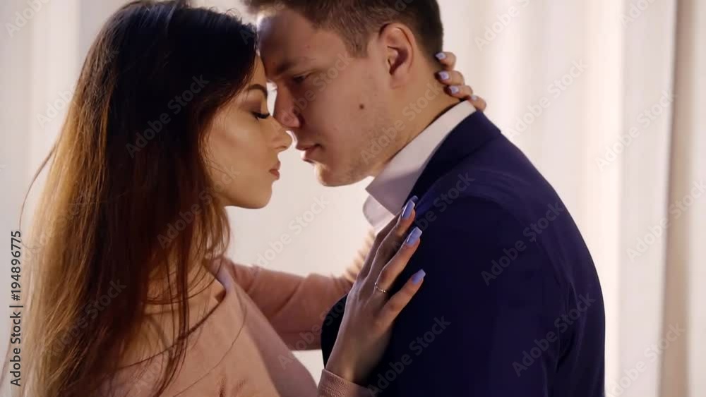 boy is hugging and kissing her girlfriend to neck, girl is stroking him, then they are drifting apart boy is hugging and kissing her girlfriend to neck, girl is stroking him, then they are drifting apart