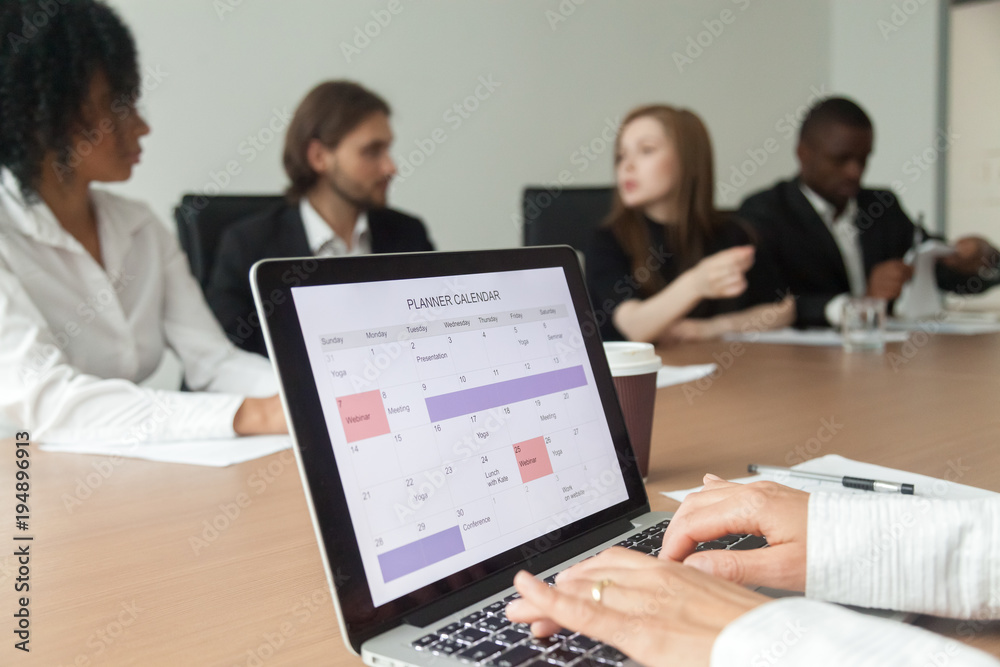 Woman using digital organizer or calendar application on laptop screen, businesswoman making events schedule with planner at office team meeting, time management and planning concept, close up view Woman using digital organizer or calendar application on laptop screen, businesswoman making events schedule with planner at office team meeting, time management and planning concept, close up view