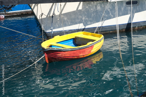 small red-yellow-blue boat