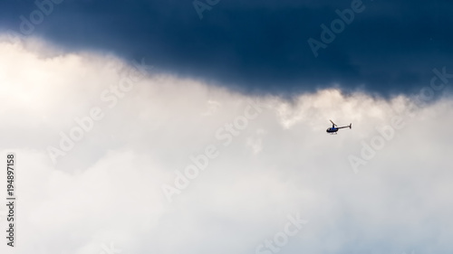 Helicopter in sky on storm background