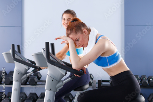 Group of people at the gym exercising on cross trainers. people at the gym photo