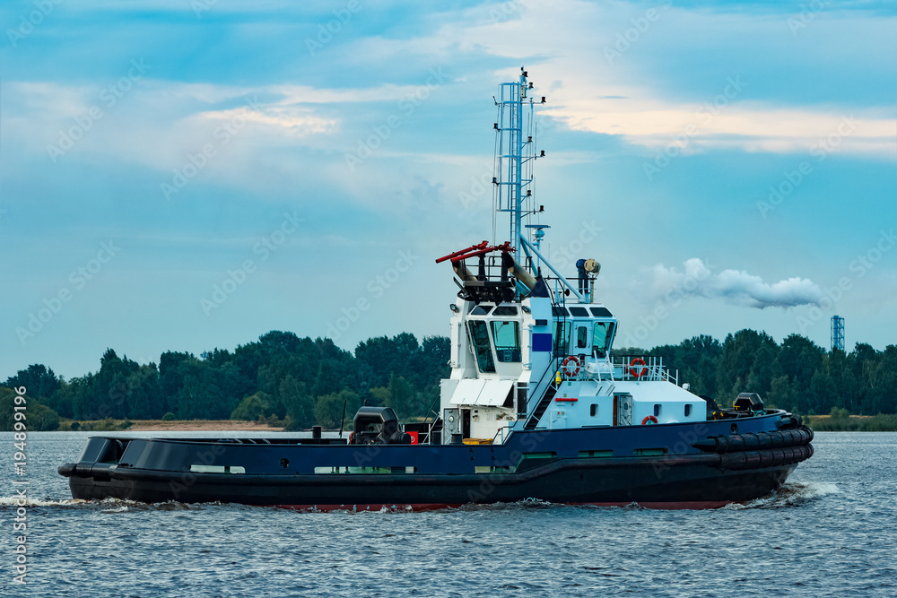 Fototapeta premium Black tug ship underway