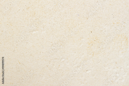 Texture of light cream paper, background for design with copy space text or image. Recyclable material, has small inclusions of cellulose
