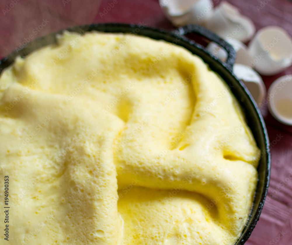Freshly cooked omelette in a frying pan. Steam rises from the omelet. Freshly cooked omelette in a frying pan. Steam rises from the omelet.