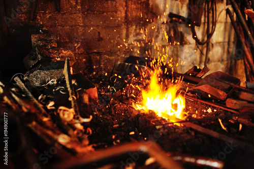Fototapeta blacksmith tools in a hot oven close-up
