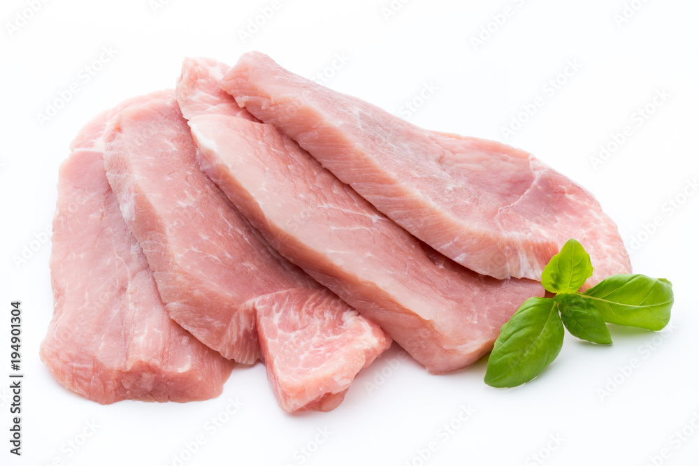 Fresh pork fillet with basil on a white background. Fresh pork fillet with basil on a white background.