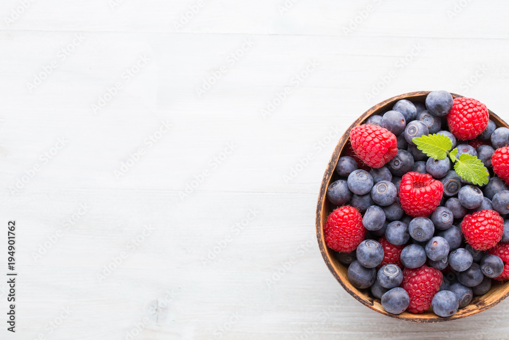 Juicy and fresh blueberries with green mint on rustic blue table. Juicy and fresh blueberries with green mint on rustic blue table.